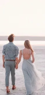 Romantic couple walking on a tranquil beach at sunset, hand in hand, serene and beautiful.