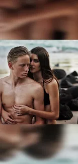 Romantic couple embracing on a scenic beach with ocean backdrop.