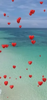 Romantic beach with red hearts floating over turquoise waters.