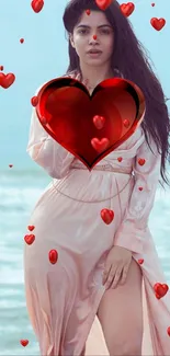 Woman in a pink dress with red hearts on a beach wallpaper.