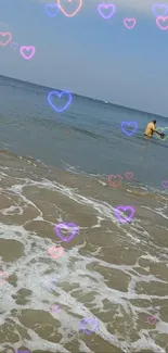 Beach wallpaper with heart shapes over ocean waves.