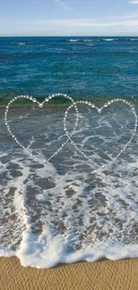 Beach with heart designs and blue ocean waves.