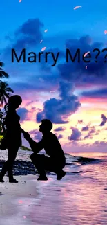 Silhouette of a proposal on a beach at sunset with vibrant colors.