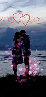 Silhouette of a couple embracing by the seaside with heart shapes above.