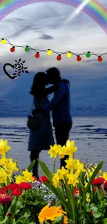 Romantic beach silhouette wallpaper with couple, flowers, and rainbow.