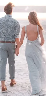 Couple walking on beach at sunset, embracing tranquility.