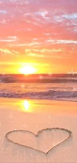 Romantic beach sunset with heart drawn in sand.