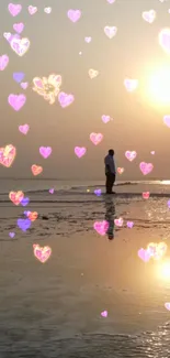 Romantic beach sunset with floating pink hearts and couple's silhouette.