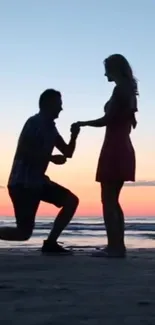 Silhouette of a couple at sunset on a beach, capturing a romantic moment.