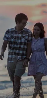 Couple walking on beach at sunset, romantic wallpaper.