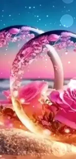 Glass rings and pink roses on a romantic beach at sunset with vibrant colors.