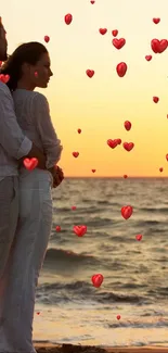 Couple embracing on beach at sunset, ocean waves gently breaking.