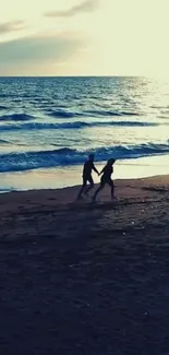 Couple walking on beach at sunset, creating a romantic ocean view wallpaper.