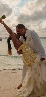 Couple embracing passionately on beach at sunset wedding.