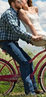 Couple enjoying a romantic bike ride on a pink bicycle in a scenic outdoor setting.