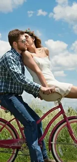 Couple on a bicycle enjoying a romantic ride under a bright blue sky.