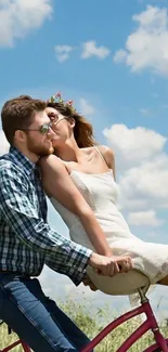 Couple on bike under blue sky.