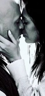 Black and white image of a couple kissing passionately.