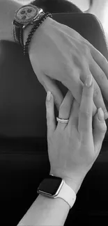 Two hands holding in black and white setting.