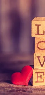 Romantic wallpaper with wooden blocks spelling 'LOVE' and a red heart.