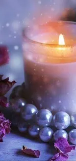 Romantic candle surrounded by flowers and pearls wallpaper.