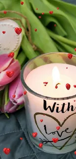 Candle with 'With Love' text and pink tulips on textured background.