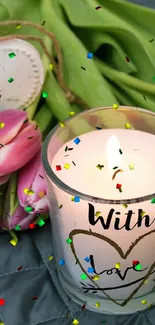 Romantic scene with candle and pink tulips on gray quilt.