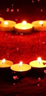 Romantic heart-shaped candle arrangement with red backdrop.