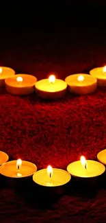 Heart-shaped candle arrangement on a dark red background, creating a romantic ambiance.