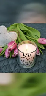 Romantic candle and tulips on dark fabric with heart decorations.