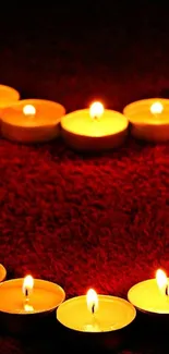 Heart-shaped candlelight on rich red texture.