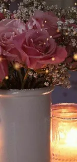 Pink roses and candlelight in vase scene.