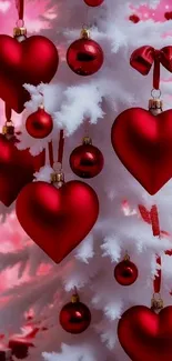 Red heart ornaments on a white Christmas tree for a holiday-themed mobile wallpaper.