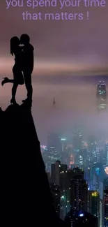 Silhouette of a couple kissing atop a cliff with a misty cityscape background.