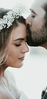 Romantic couple embracing with soft floral backdrop.