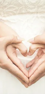 Couple forming heart shape with hands, symbolizing love and unity.