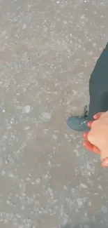 Couple holding hands on a gravel path, symbolizing romantic connection.