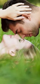 Romantic couple laying on green grass in an intimate setting.