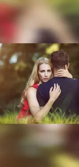 Romantic couple embracing in a lush, green outdoor setting.