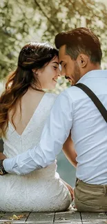 Couple embracing in a serene, leafy setting.