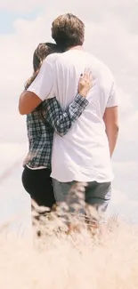 Romantic couple embracing in a sunny field.