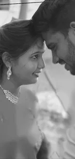 Romantic couple in black and white scene sharing an intimate moment.