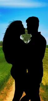 Romantic silhouette of a couple in nature with a blue sky background.