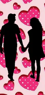 Silhouette of a couple holding hands, pink heart background.