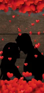 Silhouette of couple with falling red hearts on wooden background.