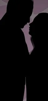 Silhouette of a couple embracing against a purple heart-themed background.