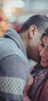 Romantic couple smiling in a cozy winter embrace.