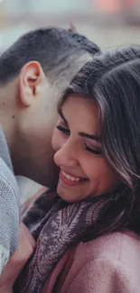 Romantic couple enjoying festive lights with warm embrace.