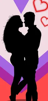 Silhouette of a couple with hearts on a colorful background.