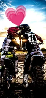 Couple on dirt bikes share a kiss under a pink heart at sunset.